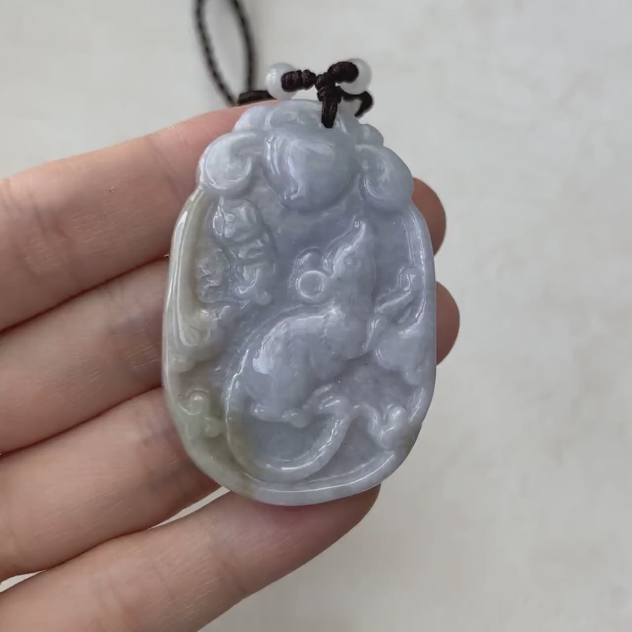 Video of a hand-carved purple jadeite Rat pendant with yellow accents and subtle green hints, elegant and unique