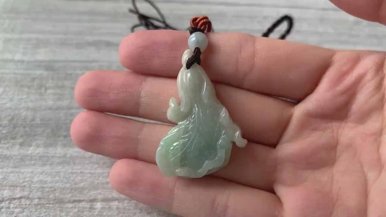 Video of a hand-carved jade cabbage pendant in olive and apple green tones, elegant and timeless