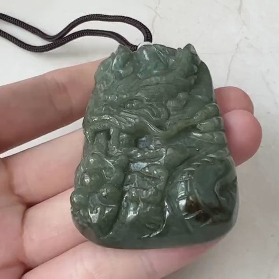 Video of a finely carved dragon pendant with detailed scales, claws, tail, and face in a striking statement style