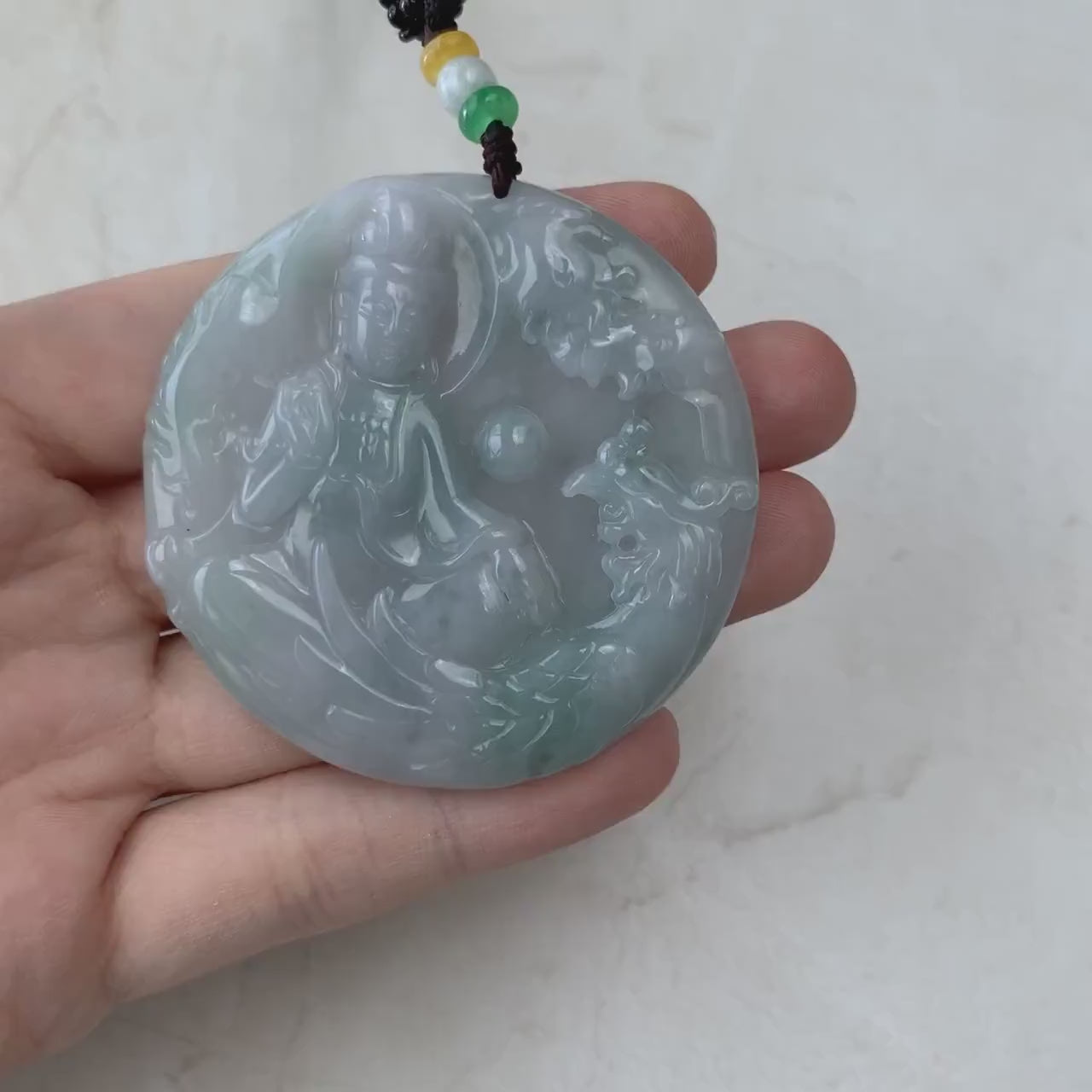 Video of hand-carved natural jadeite jade pendant with Guan Yin and phoenix in flowing light green hues