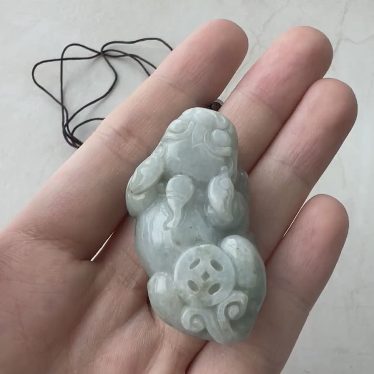 Video of hand-carved jade Pi Xiu with intricate detailing, bold expression, and a majestic traditional style