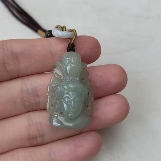 Video of a hand-carved natural jade Guan Yin head pendant in unique undyed green tones with graceful detail