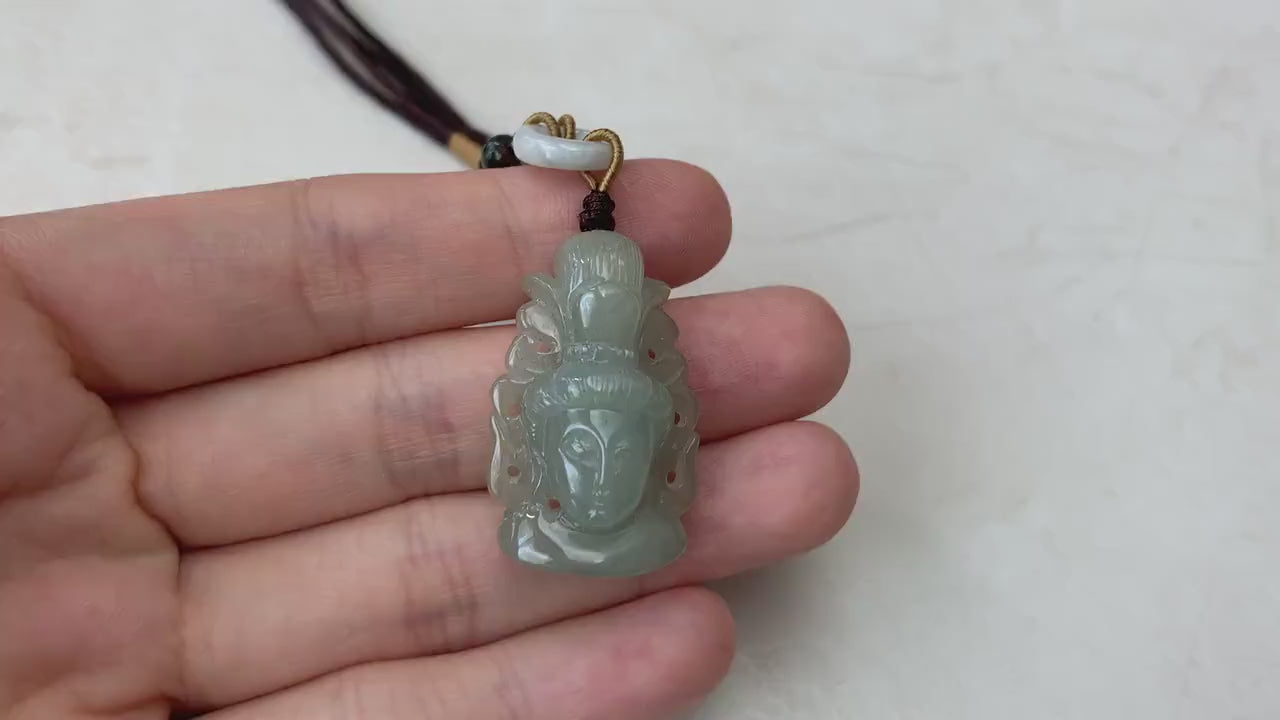 Video of a hand-carved natural jade Guan Yin head pendant in unique undyed green tones with graceful detail