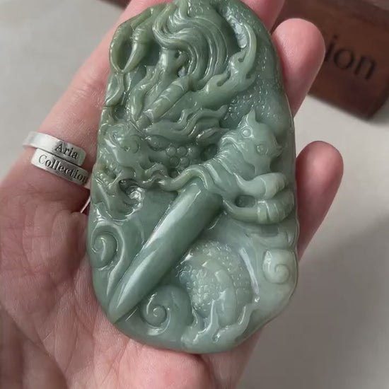 Video of a hand-carved natural green jadeite pendant with a dragon and Guardian Blade, ornate East Asian talisman style