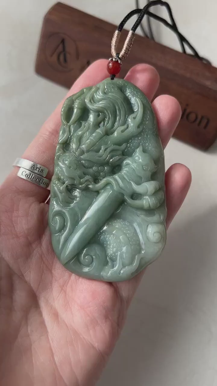 Video of a hand-carved natural green jadeite pendant with a dragon and Guardian Blade, ornate East Asian talisman style