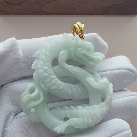Video of pale mint-green natural jade double-dragon pendant with openwork carving and gold-tone bail