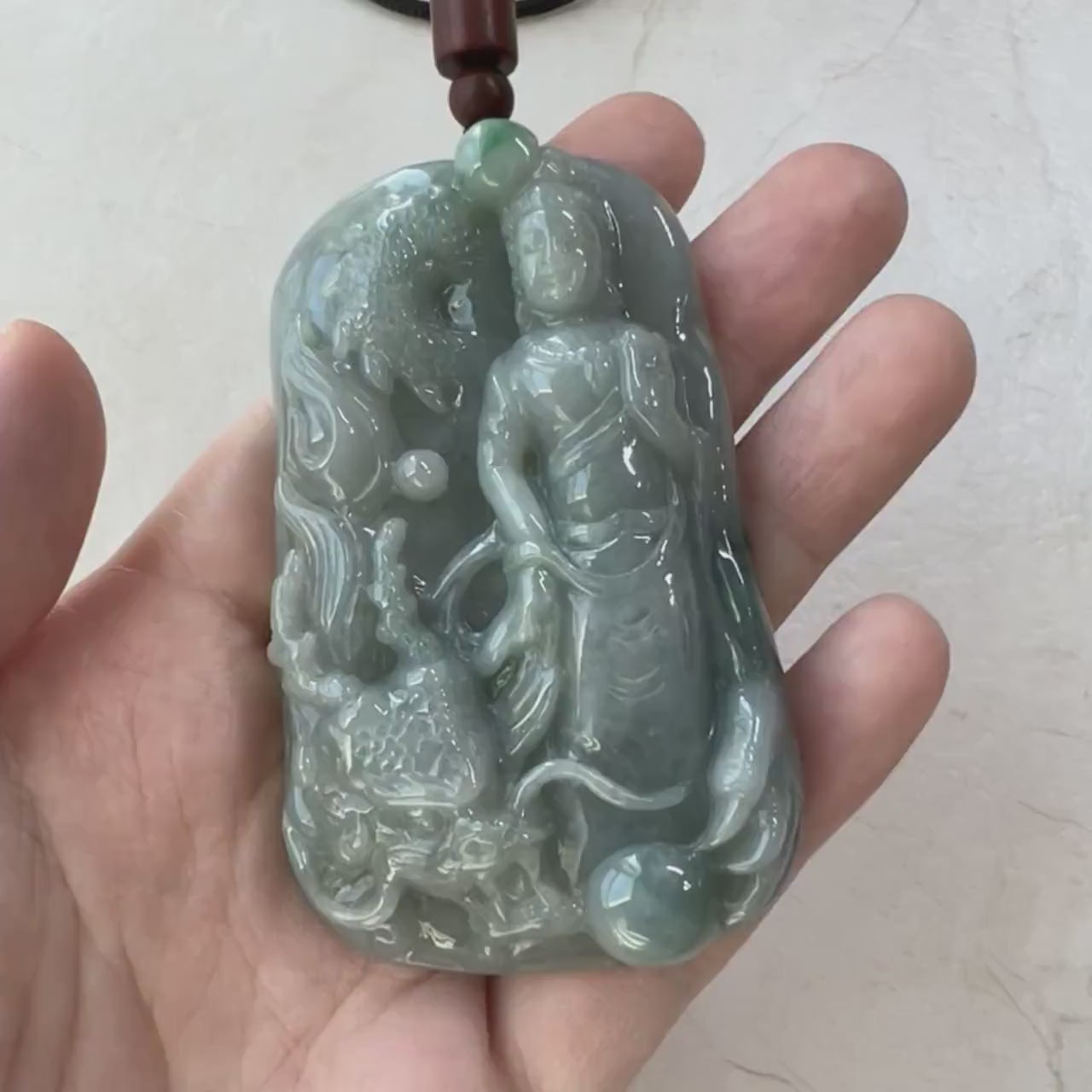 Video of a hand-carved natural jadeite jade pendant with Guan Yin, dragon detail, and intricate dual-sided carving