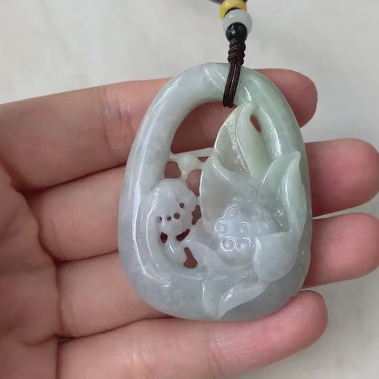 Video of a hand-carved jadeite jade lotus pendant in green openwork with a three-dimensional floral design