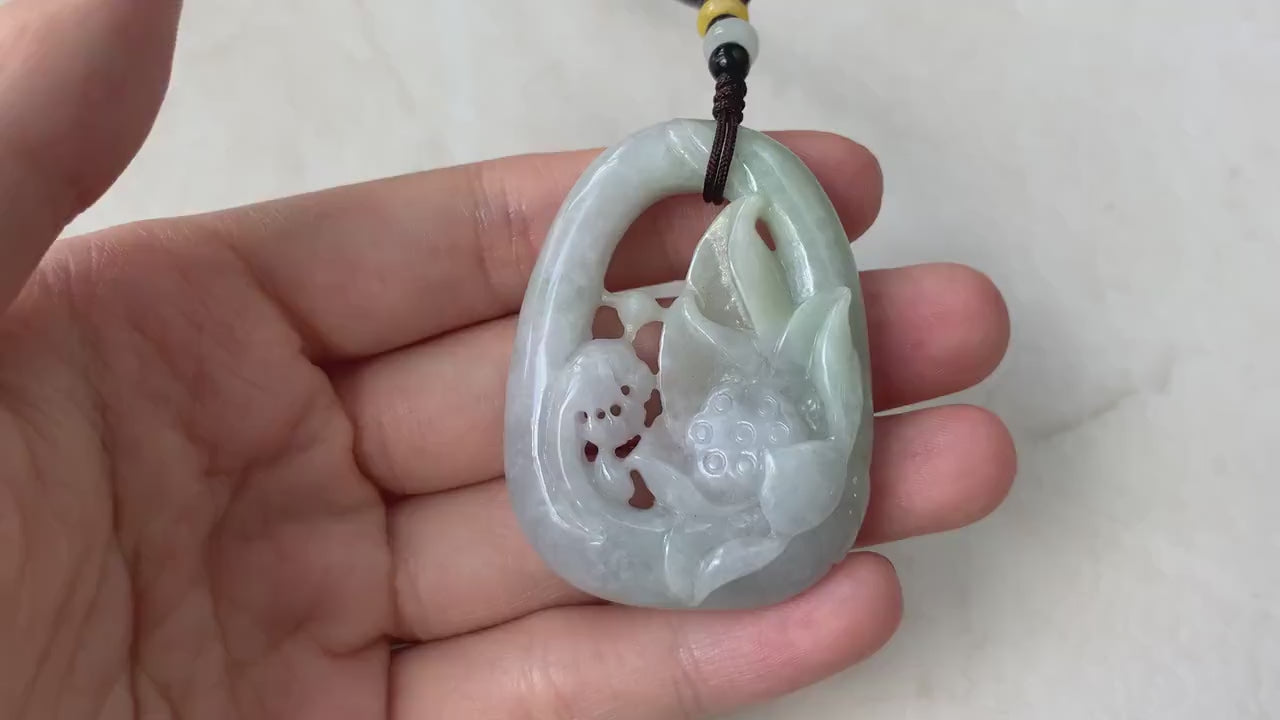 Video of a hand-carved jadeite jade lotus pendant in green openwork with a three-dimensional floral design