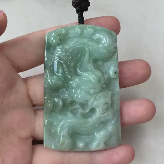 Video of hand-carved green jade Chinese zodiac dragon pendant with intricate details and unique sculpted design