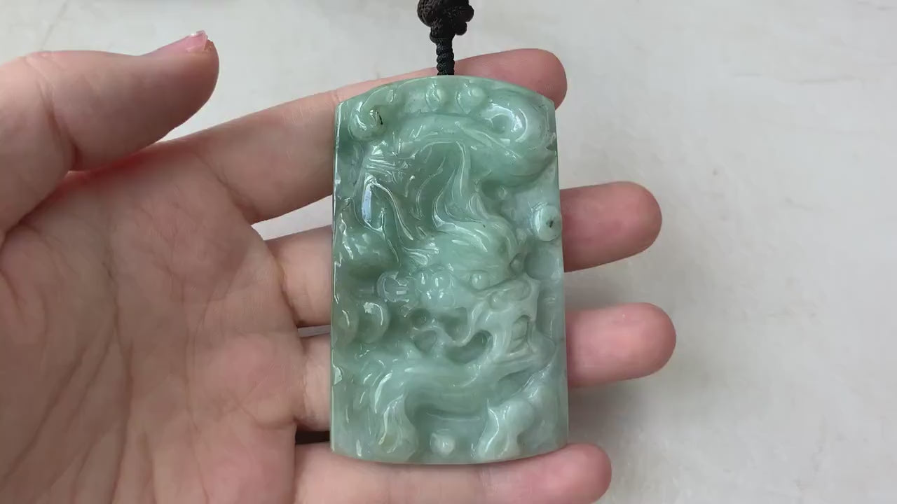 Video of hand-carved green jade Chinese zodiac dragon pendant with intricate details and unique sculpted design