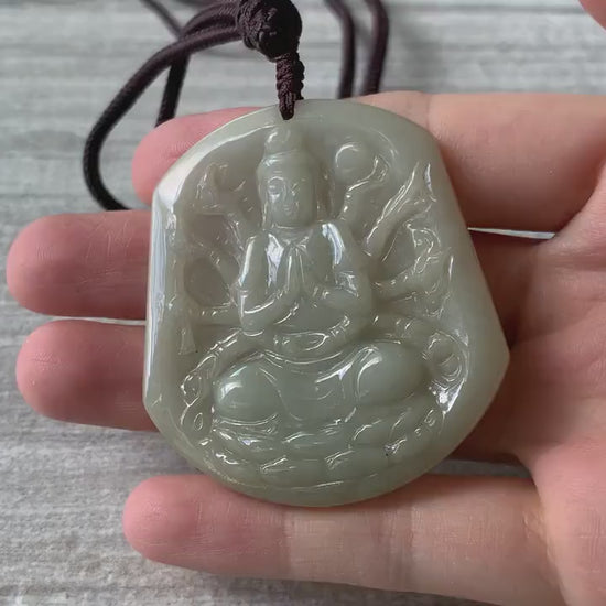 Video of a hand-carved natural jadeite pendant in olive green and light yellow with a soft translucent glow