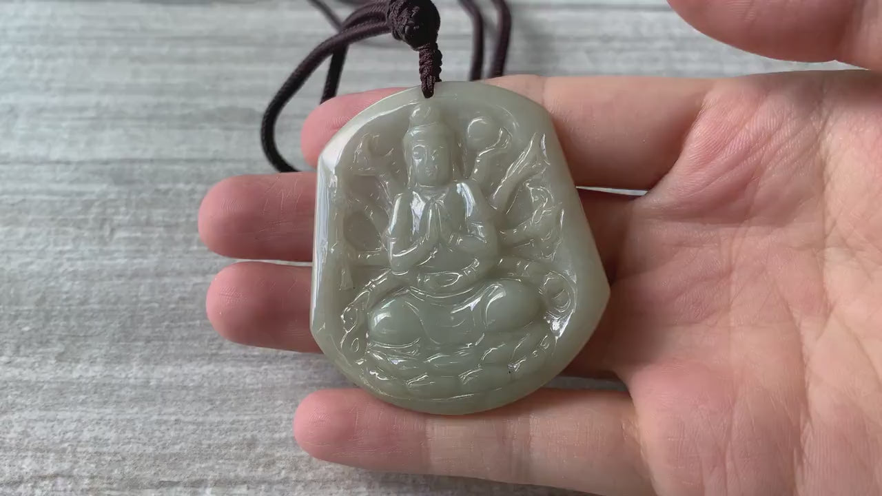 Video of a hand-carved natural jadeite pendant in olive green and light yellow with a soft translucent glow