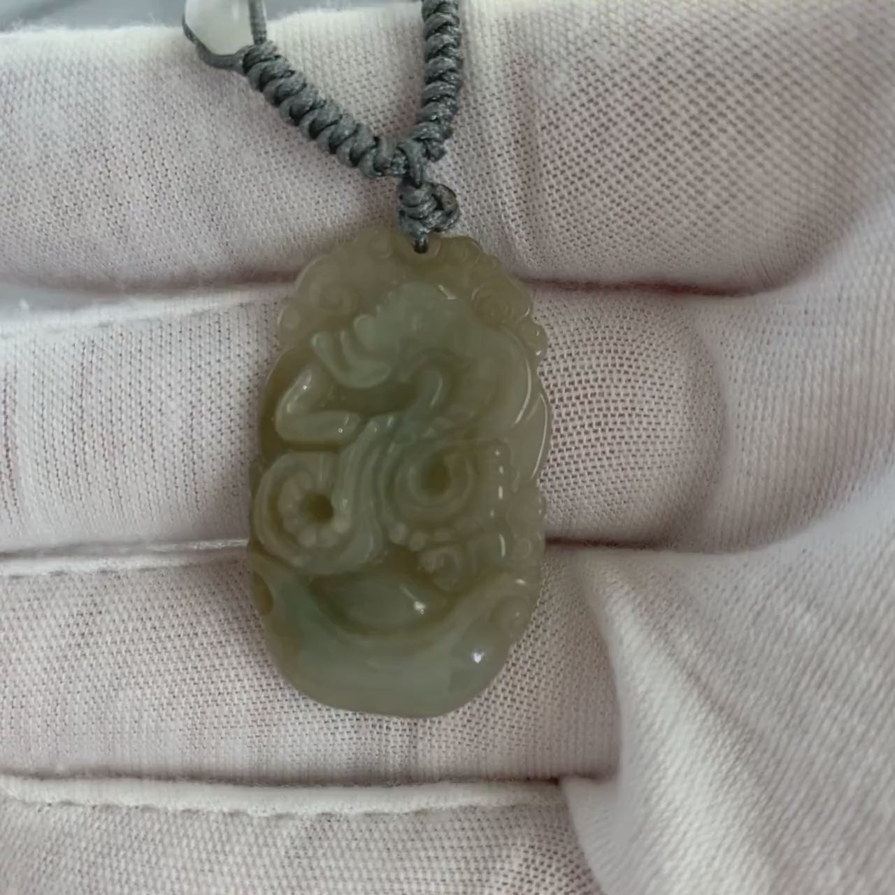 Video of a jadeite jade snake pendant necklace with natural hand-carved green beads and rustic stone texture