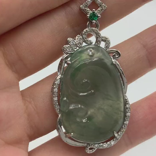 Video of light green translucent jadeite Ruyi pendant in elegant sterling silver frame, classic carved style