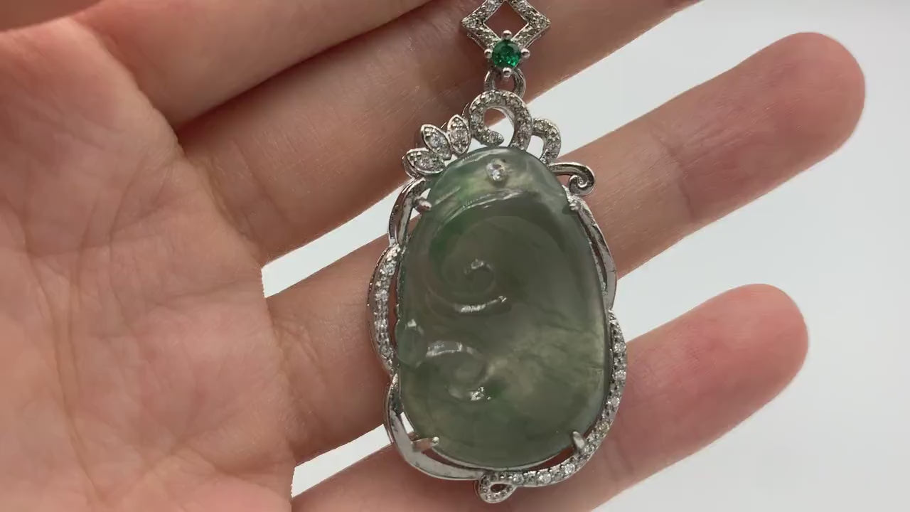 Video of light green translucent jadeite Ruyi pendant in elegant sterling silver frame, classic carved style