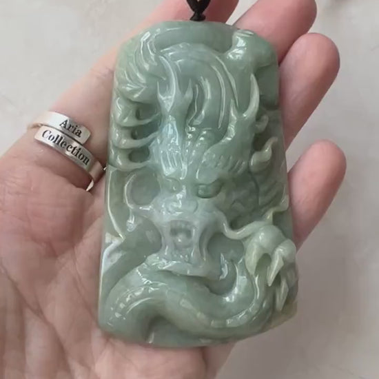 Video of a hand-carved green jadeite dragon talisman with rich natural hues and ancient-inspired style