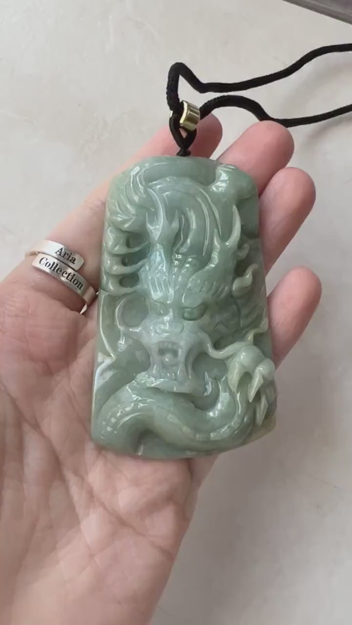 Video of a hand-carved green jadeite dragon talisman with rich natural hues and ancient-inspired style