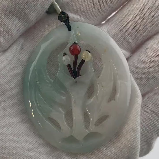 Video of a hand-carved green jade flower pendant on an adjustable necklace, unique natural stone variations