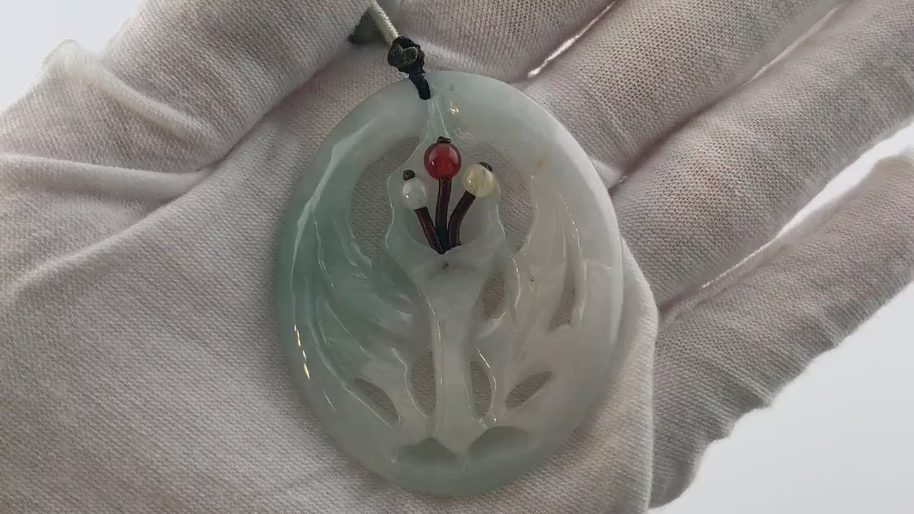 Video of a hand-carved green jade flower pendant on an adjustable necklace, unique natural stone variations
