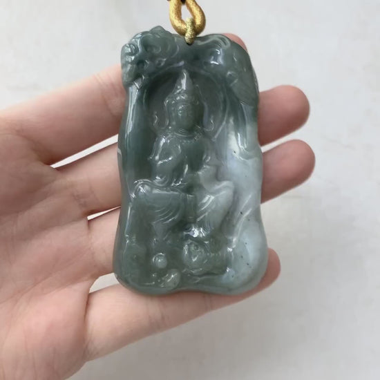 Video of a hand-carved green jade Guan Yin pendant on a carved lotus, serene and intricate.