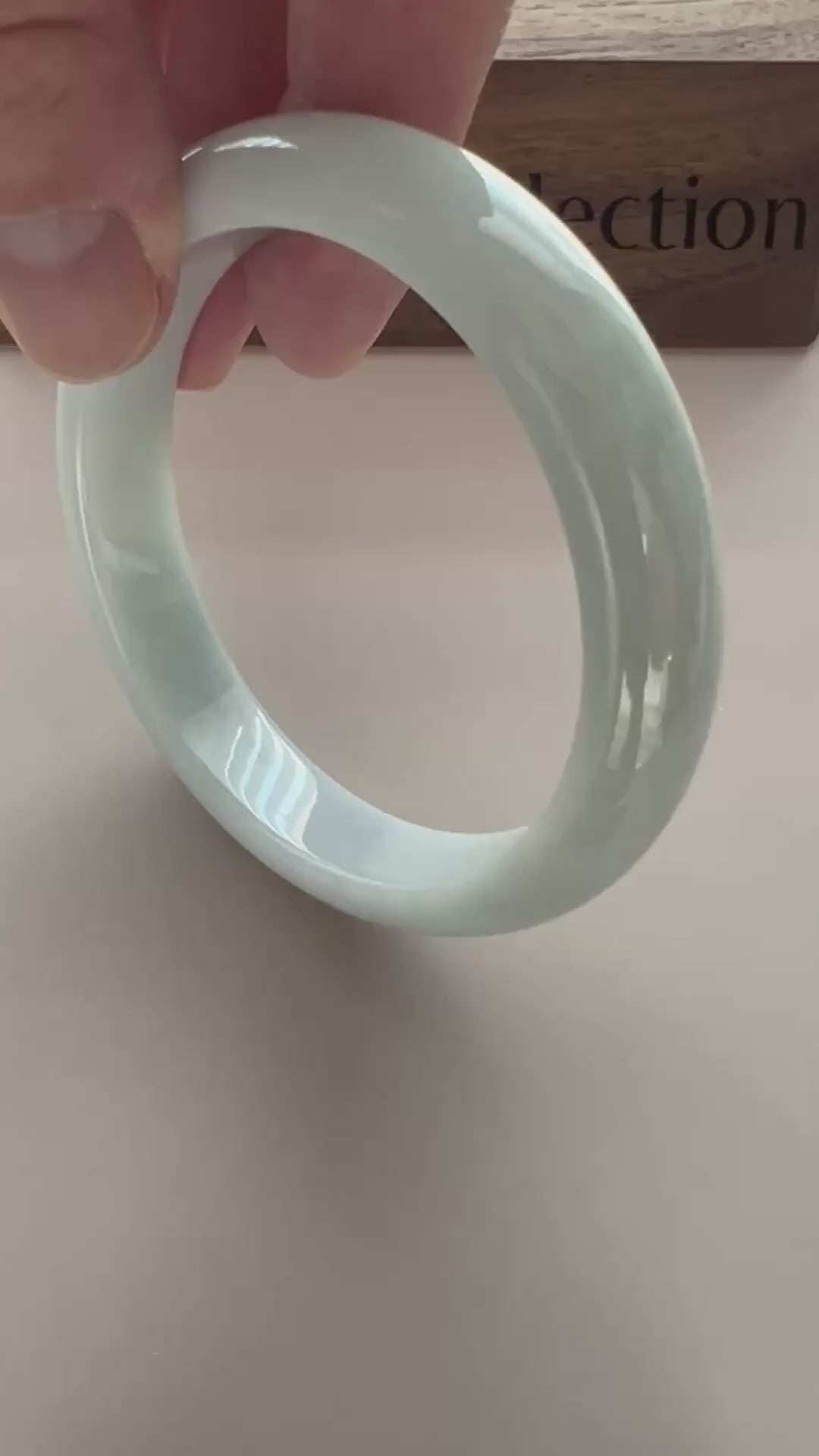 Video of a classic Burmese Type A jadeite bangle in icy light green-blue with a smooth, high-polish rounded profile