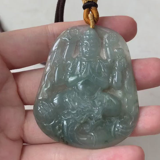 Video of hand-carved green jadeite Guan Yin pendant with thousand arms, semi-translucent glow, intricate detail