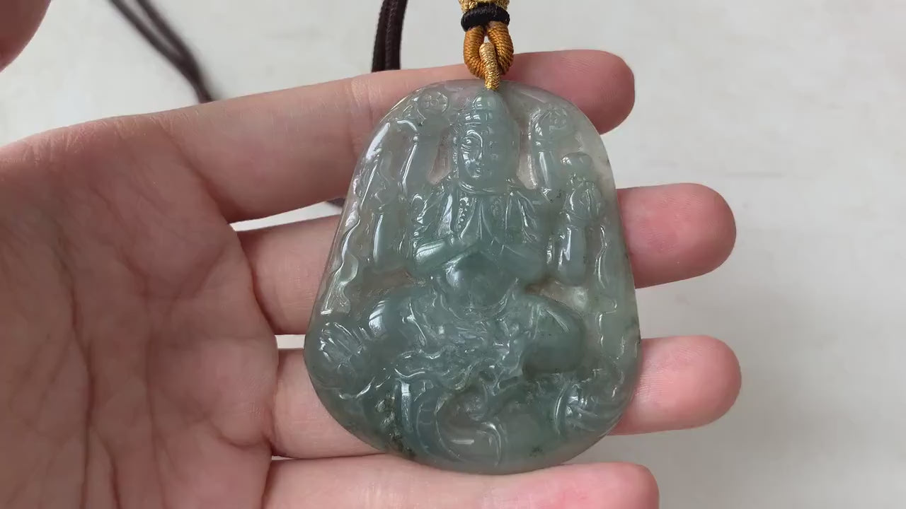 Video of hand-carved green jadeite Guan Yin pendant with thousand arms, semi-translucent glow, intricate detail
