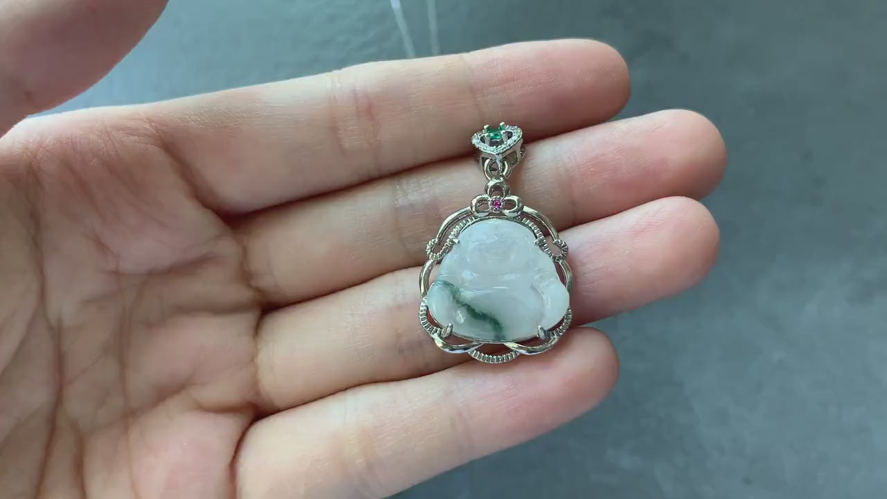Video of a hand-carved white jadeite Laughing Buddha pendant with dark green streaks and sterling silver crown setting