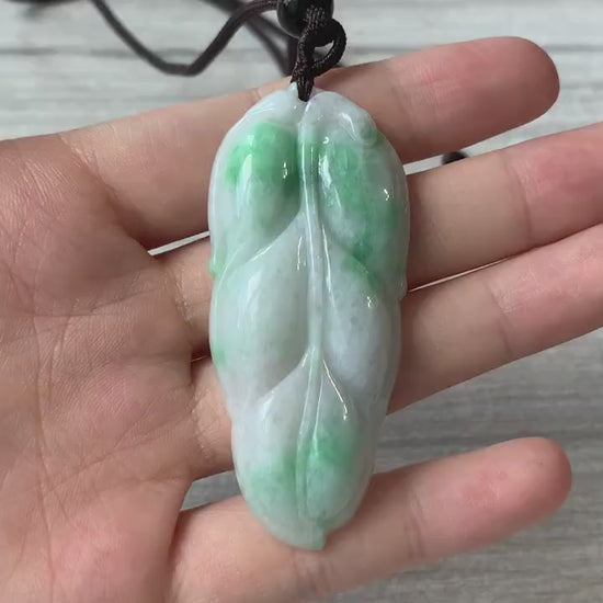 Video of a delicate hand-carved leaf pendant with a clean minimalist nature-inspired design