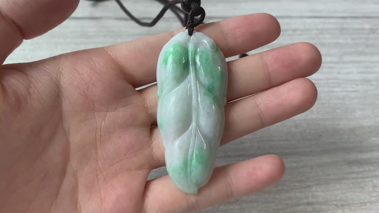 Video of a delicate hand-carved leaf pendant with a clean minimalist nature-inspired design