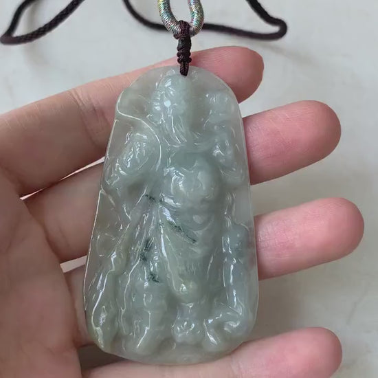 Video of a hand-carved natural jadeite jade Guan Gong pendant in rich green with detailed, artisanal carving