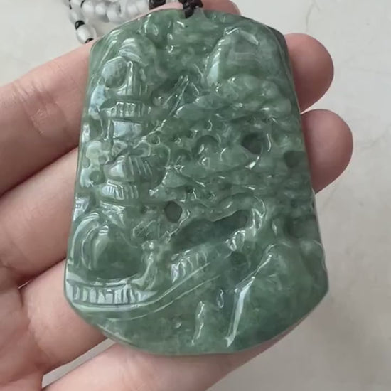 Video of a green jadeite pendant with hand-carved mountain forest scene and adjustable bead necklace