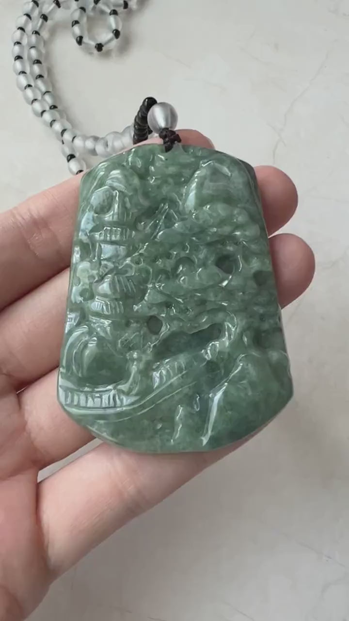 Video of a green jadeite pendant with hand-carved mountain forest scene and adjustable bead necklace