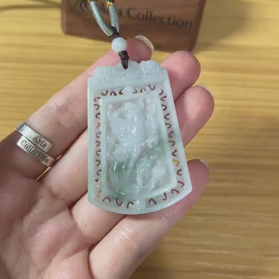 Video of a light green jadeite pendant with intricate hand-carved dragon and phoenix motifs, elegant and rare