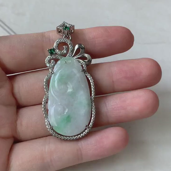 Video of a hand-carved milky white jadeite Ruyi pendant with green highlights in an elegant sterling silver setting