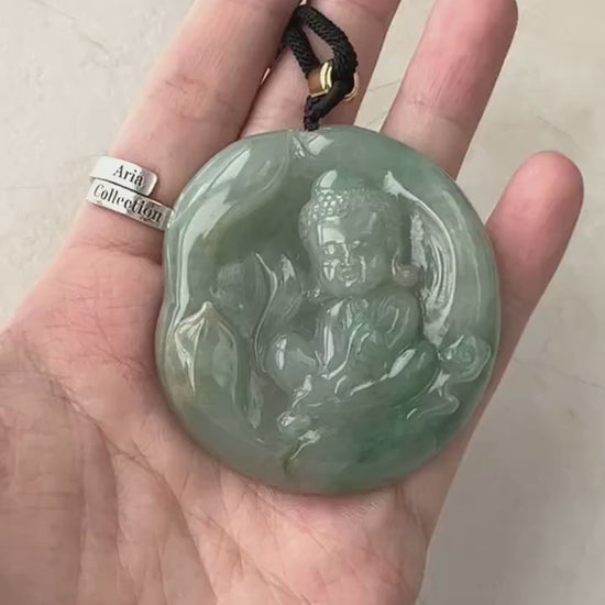 Video of a hand-carved pendant with a Baby Buddha design, serene gold-toned, dual-sided, and intricately detailed