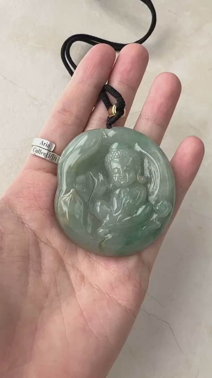 Video of a hand-carved pendant with a Baby Buddha design, serene gold-toned, dual-sided, and intricately detailed