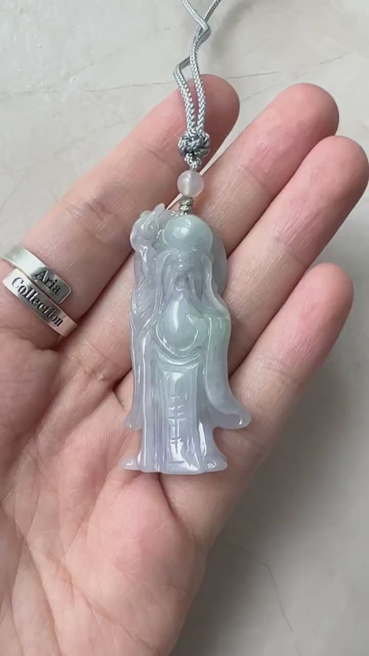 Video of hand-carved jade pendant in green with Shòuxīng figure, long beard, serene face, and traditional robes