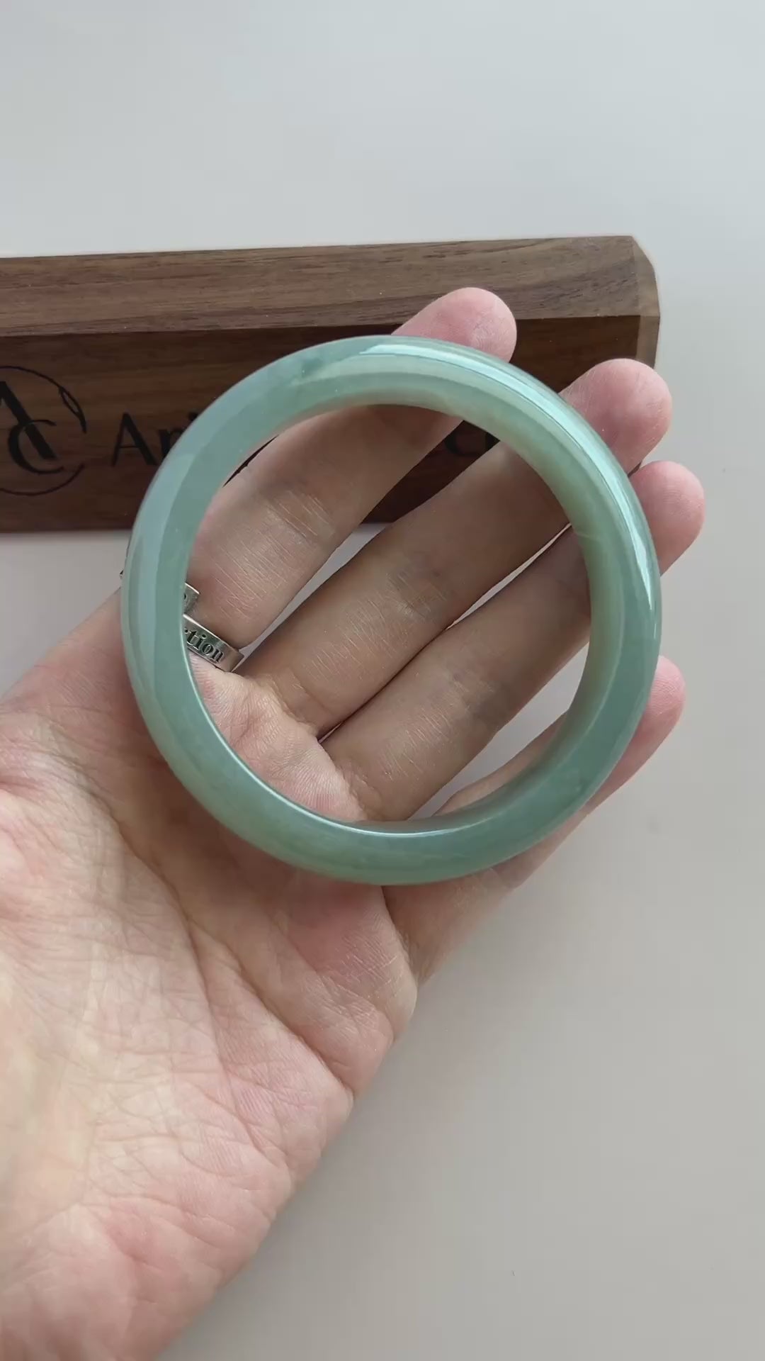 Video of a polished Burmese Type A jadeite bangle in soft light green-blue with a smooth, substantial rounded profile