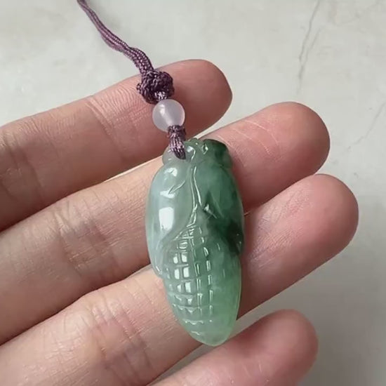 Video of a hand-carved green jade corn motif pendant with symbolic, elegant, artisanal style