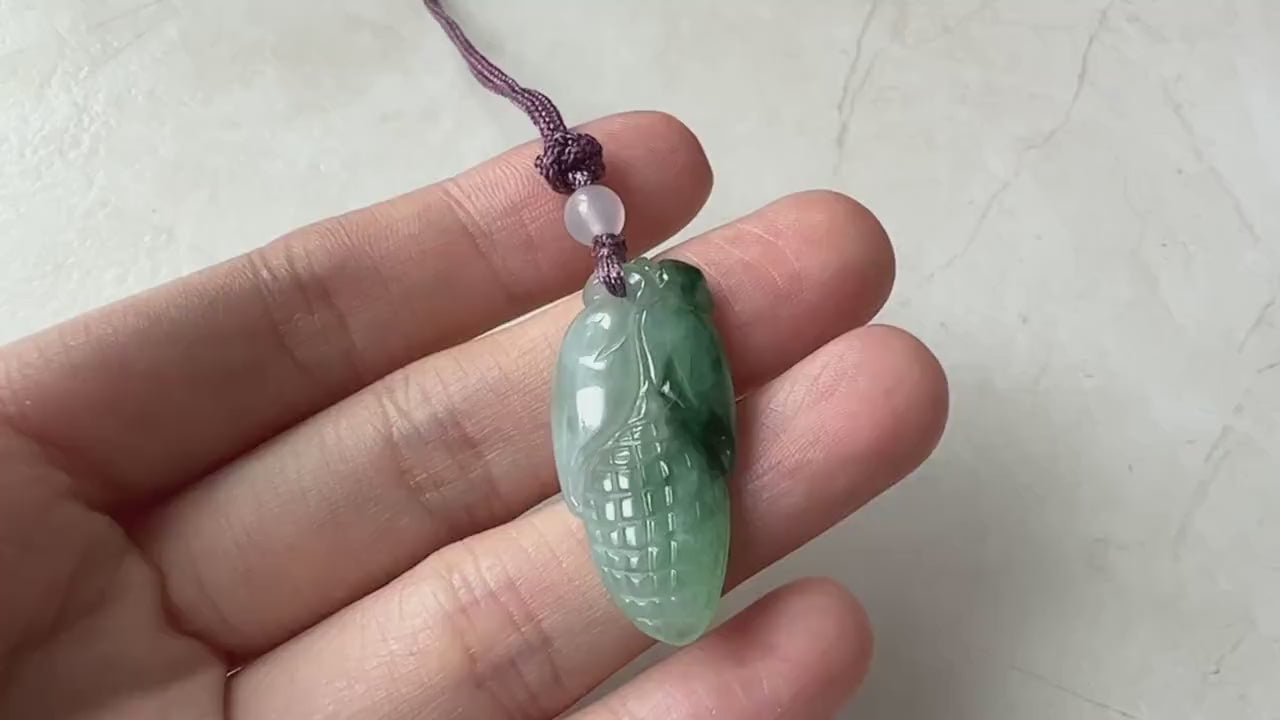 Video of a hand-carved green jade corn motif pendant with symbolic, elegant, artisanal style