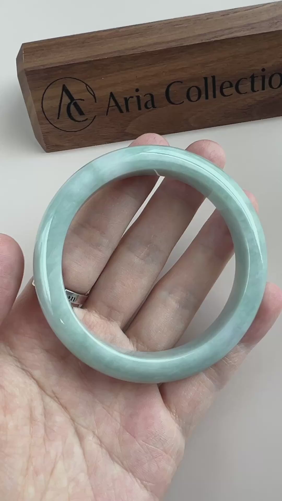 Video of a classic Burmese Type A jadeite bangle in light green-blue with a polished, semi-translucent rounded form