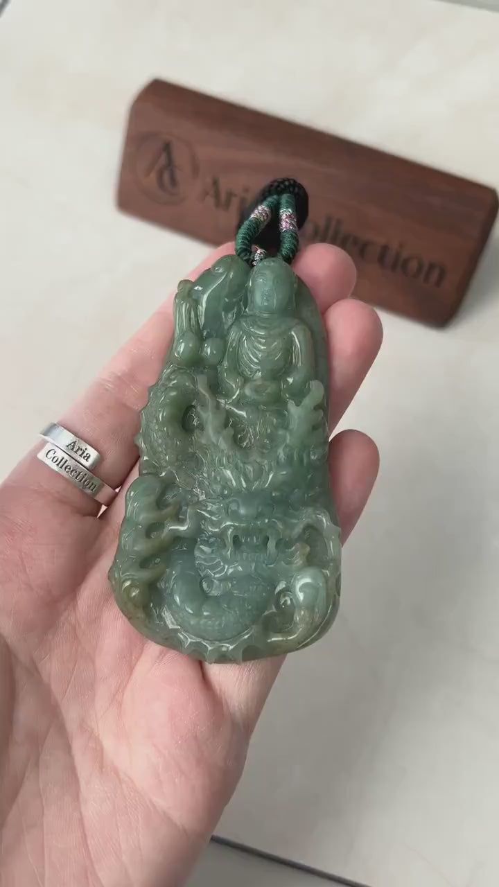Video of vibrant green jade pendant with carved Buddha and dragon, glowing with intricate spiritual detail
