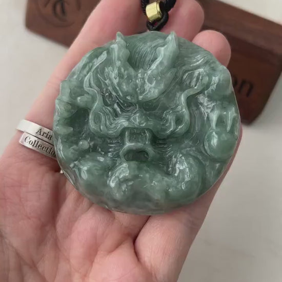 Video of a round green jadeite pendant with a hand-carved Chinese dragon, intricate and elegant.