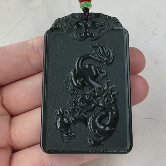 Video of a hand-carved jade pendant with Samantabhadra on an elephant and a carved dragon reverse, serene green design
