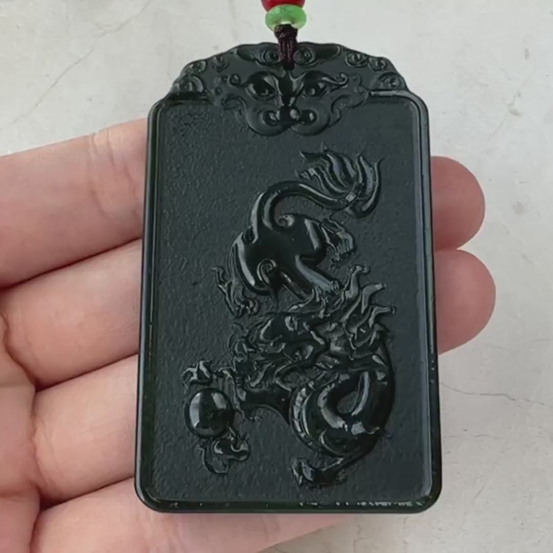 Video of a hand-carved jade pendant with Samantabhadra on an elephant and a carved dragon reverse, serene green design