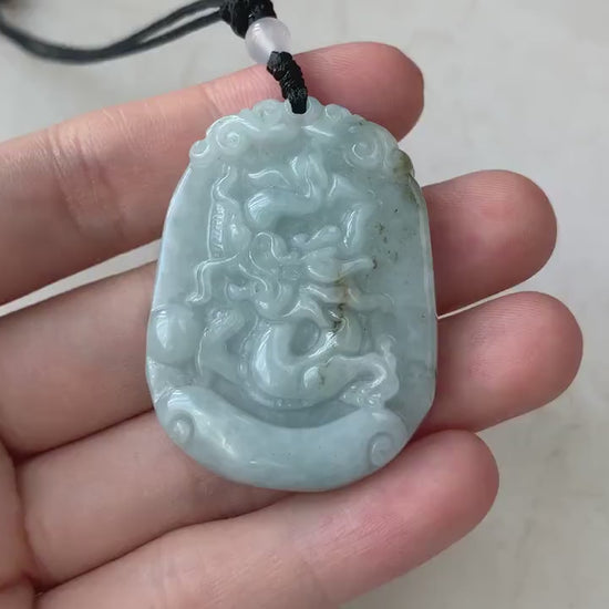 Video of a hand-carved green jadeite dragon pendant with detailed Chinese zodiac style and premium finish