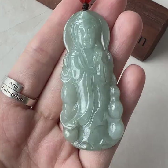 Video of a hand-carved green jade Guan Yin pendant with graceful Buddhist goddess detailing and serene, elegant style