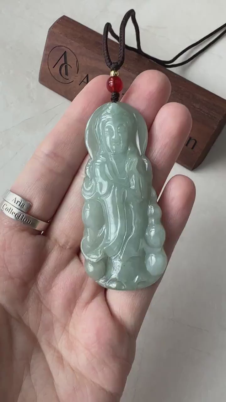 Video of a hand-carved green jade Guan Yin pendant with graceful Buddhist goddess detailing and serene, elegant style
